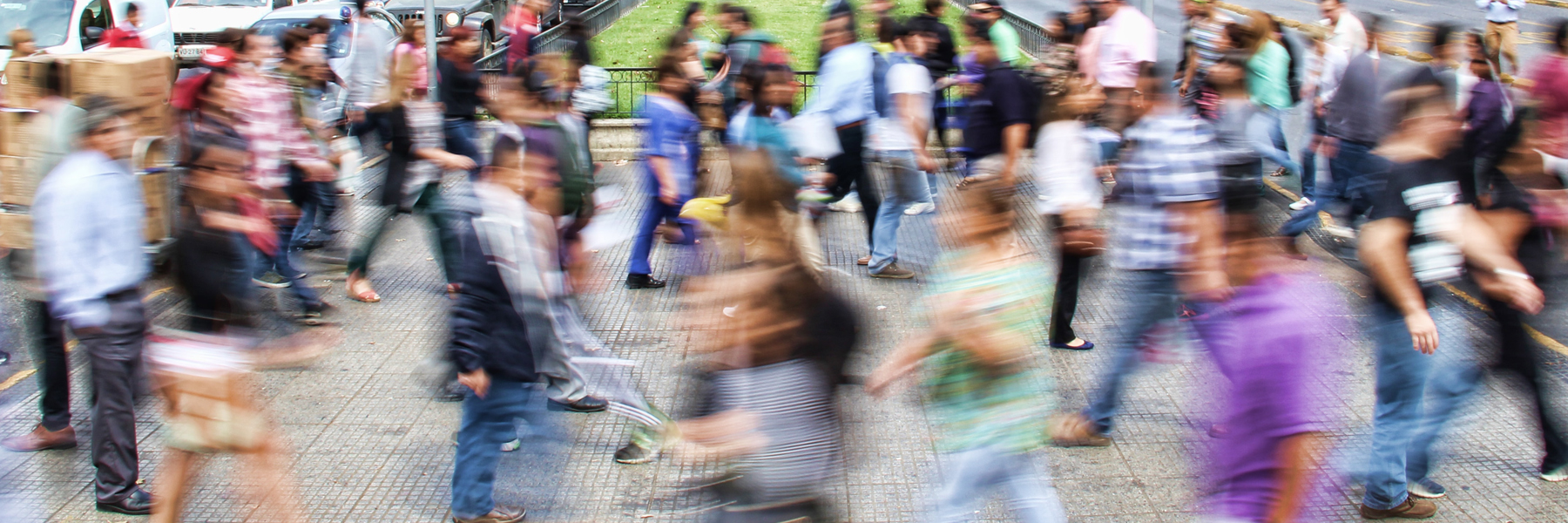 Blurred people walking across a street